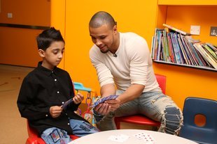 Chris plays a game of cards with heart patient Abuzar